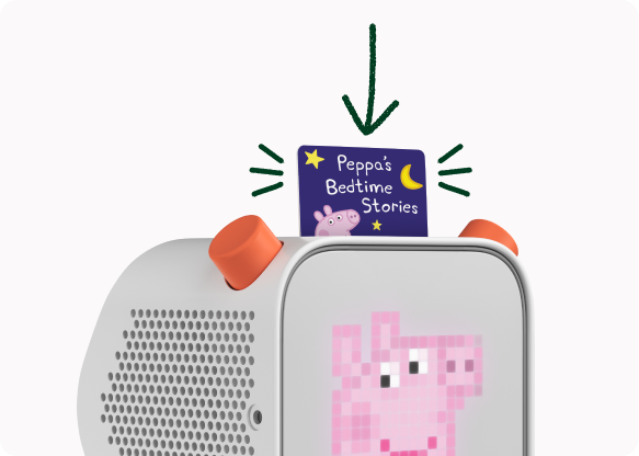 A Peppa Pig audio card inserted into a Yoto Player, which shows Peppa on its pixel display.
